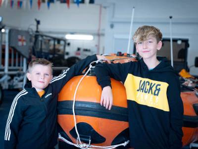 Nine-year-old saved by RNLI Float to Live advice returns to lifeboat station to thank his rescuer and Lifeboat crew