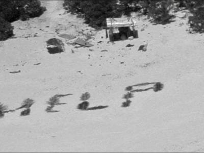 Castaways rescued after writing ‘help’ on beach